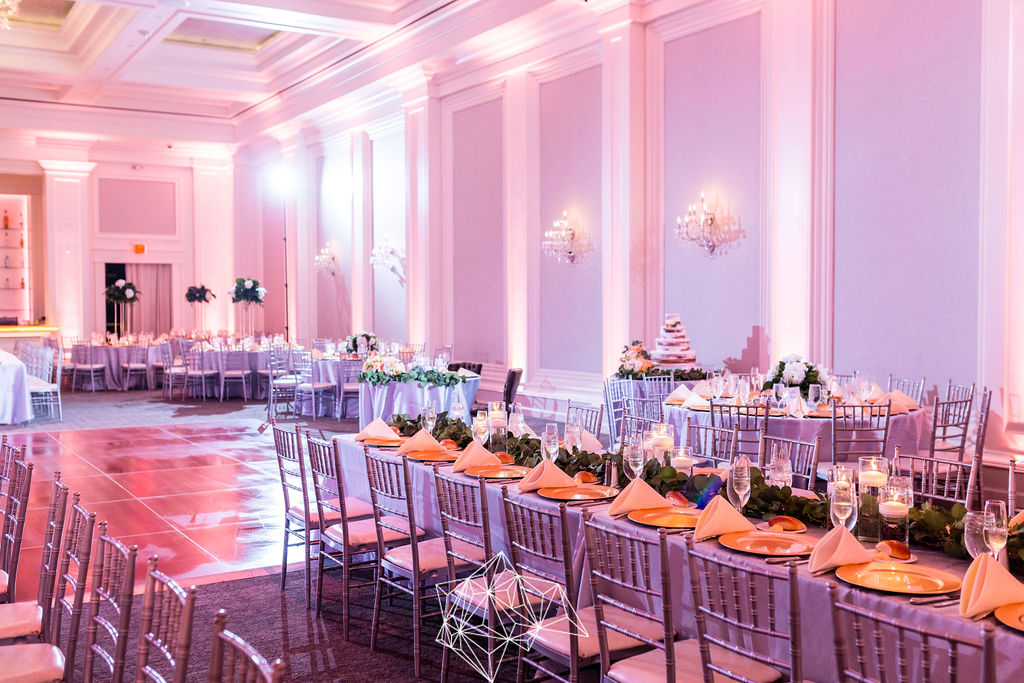 Elegant wedding reception ballroom with pink uplighting, greenery garland head table, and tall faux floral centerpieces, Ballroom at Ellis Preserve Delaware County Pennsylvania